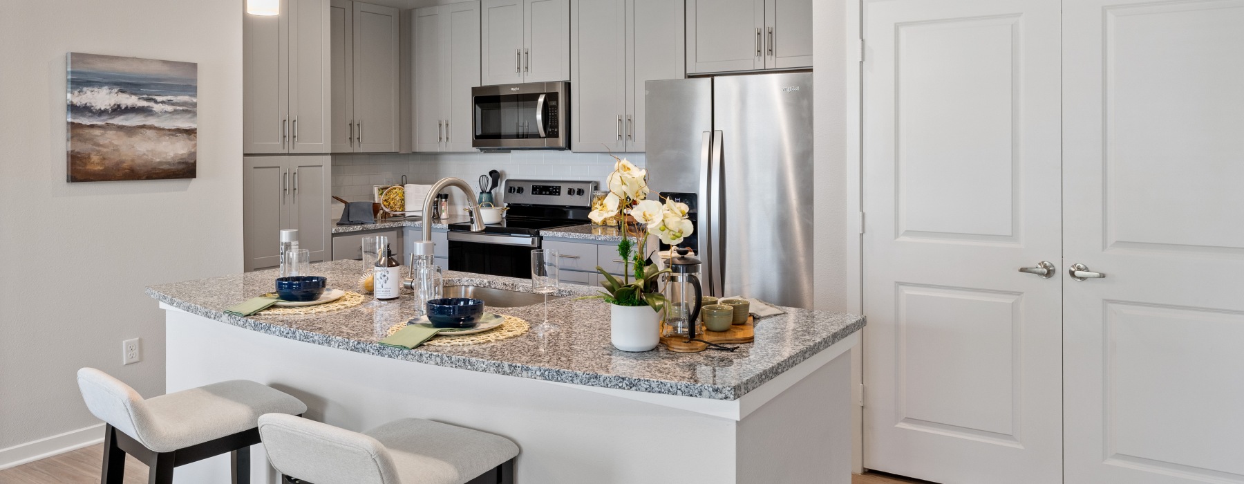 a kitchen with grey cabinets